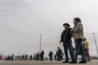 People queue to be vaccinated against COVID-19 at the Wanda Metropolitano stadium, Madrid, Spain, March 30, 2021. Spain is trying to stamp out a new wave of COVID-19 among its youth thanks to a robust vaccination program that is widely supported. Spain like the rest of the European Union got off to a slow start to compared to the United States and Britain when the first vaccines were released. But it has quickly made up ground once deliveries by drug makers started flowing. (AP Photo/Olmo Calvo)