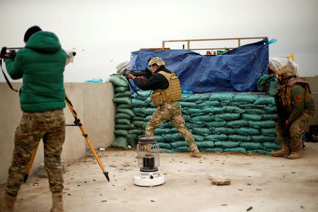 A member of the Iraqi rapid response forces fires during a battle with Islamic State militants at the Tigris river frontline near Mosul, Iraq, January 25, 2017. REUTERS/Ahmed Jadallah