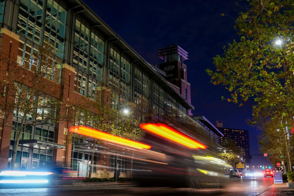 Oct 24, 2023; Columbus, Ohio, USA; Cars drive by Nationwide Arena with many exterior lights still off during a power outage delay prior to the NHL game between the Columbus Blue Jackets and the Anaheim Ducks. The start time was pushed back two hours after an electrical transformer issue knocked out power to a large part of downtown Columbus and the Arena District Tuesday afternoon.