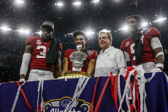 Alabama linebacker Will Anderson Jr., left, quarterback Bryce Young, center left, head coach Nick Saban, center right, and defensive back Jordan Battle, right, stand with the trophy as they celebrate after the Sugar Bowl NCAA college football game against Kansas State, Saturday, Dec. 31, 2022, in New Orleans. (AP Photo/Butch Dill)