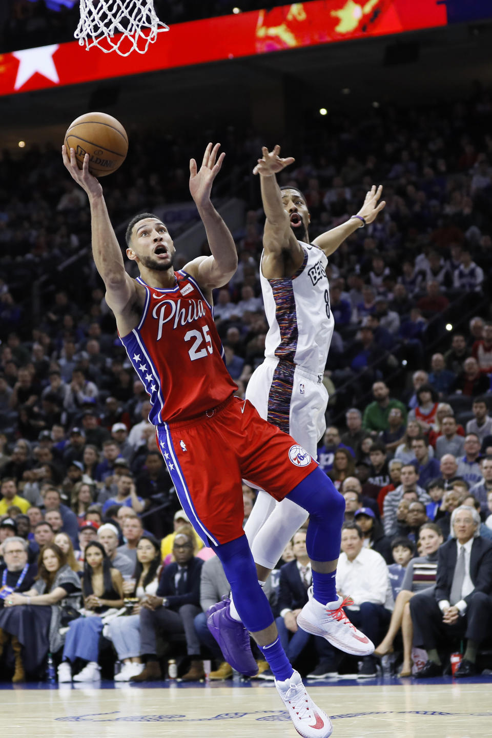 Philadelphia 76ers' Ben Simmons, left, goes up for a shot past Brooklyn Nets' Spencer Dinwiddie during the first half of an NBA basketball game, Wednesday, Jan. 15, 2020, in Philadelphia. (AP Photo/Matt Slocum)