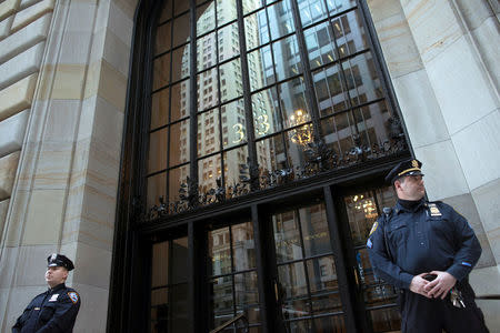 Federal Reserve and New York City Police officers stand guard in front of the New York Federal Reserve Building in New York, October 17, 2012. REUTERS/Keith Bedford/File Photo