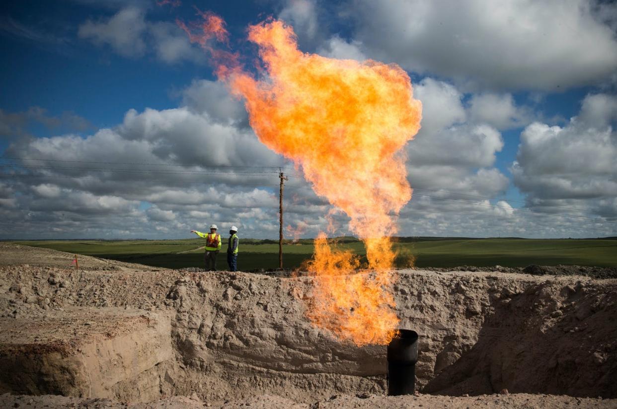 <span class="caption">Flaring gas at an oil production site outside Williston, North Dakota.</span> <span class="attribution"><a class="link " href="https://www.gettyimages.com/detail/news-photo/gas-flare-is-seen-at-an-oil-well-site-on-july-26-2013-news-photo/174480635?adppopup=true" rel="nofollow noopener" target="_blank" data-ylk="slk:Andrew Burton/Getty Images;elm:context_link;itc:0;sec:content-canvas">Andrew Burton/Getty Images</a></span>