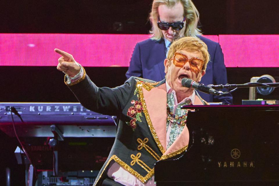 Elton John points into the crowd as he performs on stage during his "Farewell Yellow Brick Road The Final Tour" on Friday, Nov. 11, 2022, at Chase Field in Phoenix.