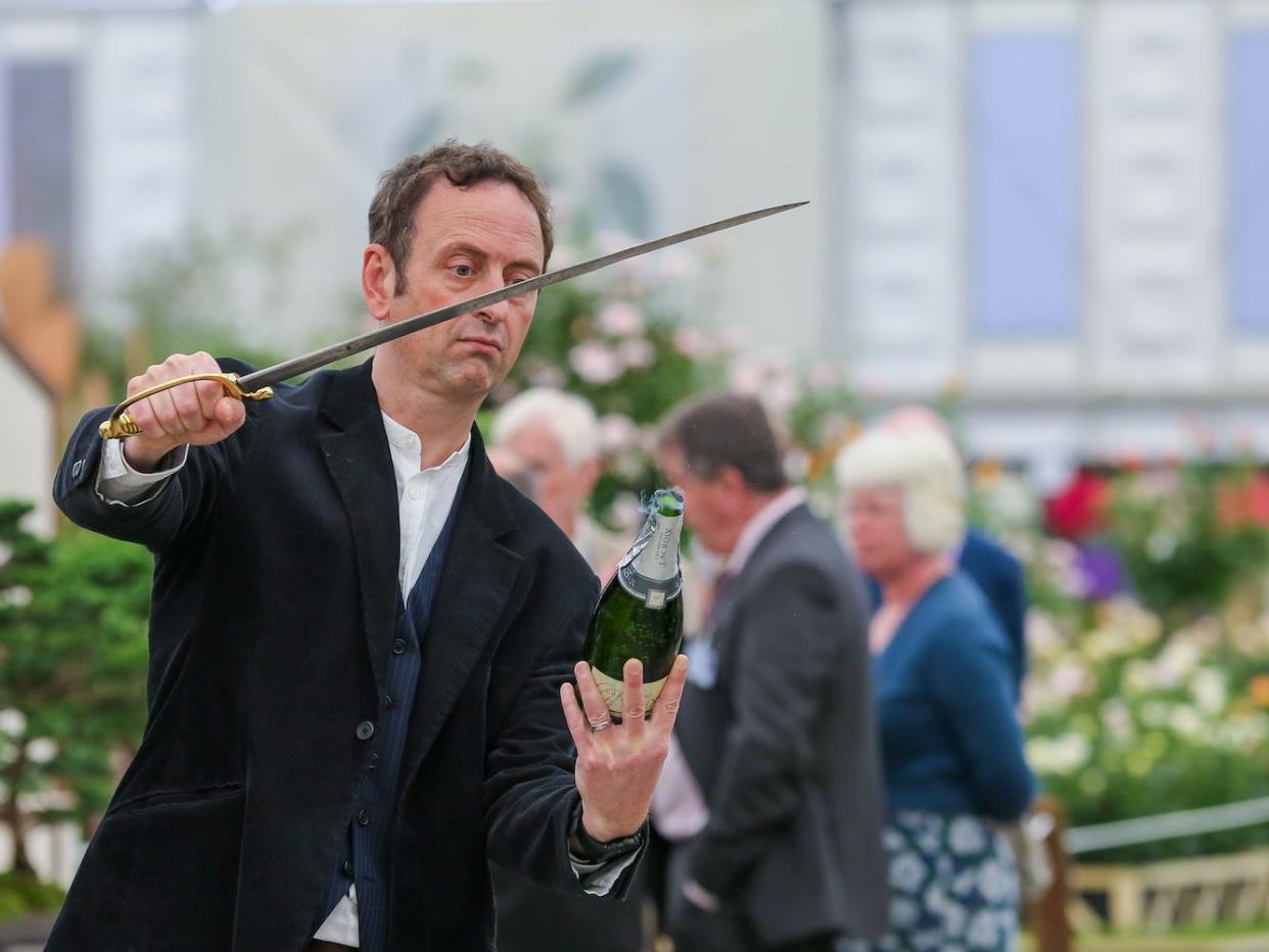 A champagne-saber ceremony at the Chelsea Flower Show in London.