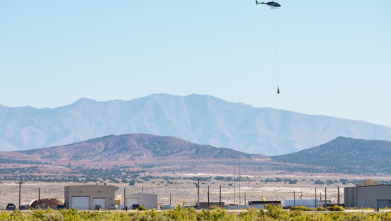 A helicopter long lines the capsule containing a sample collected from the Bennu asteroid as part of NASA’s Osiris-Rex mission from where it was retrieved to a clean room at the U.S. Army’s Dugway Proving Ground in Dugway on Sept. 24, 2023.