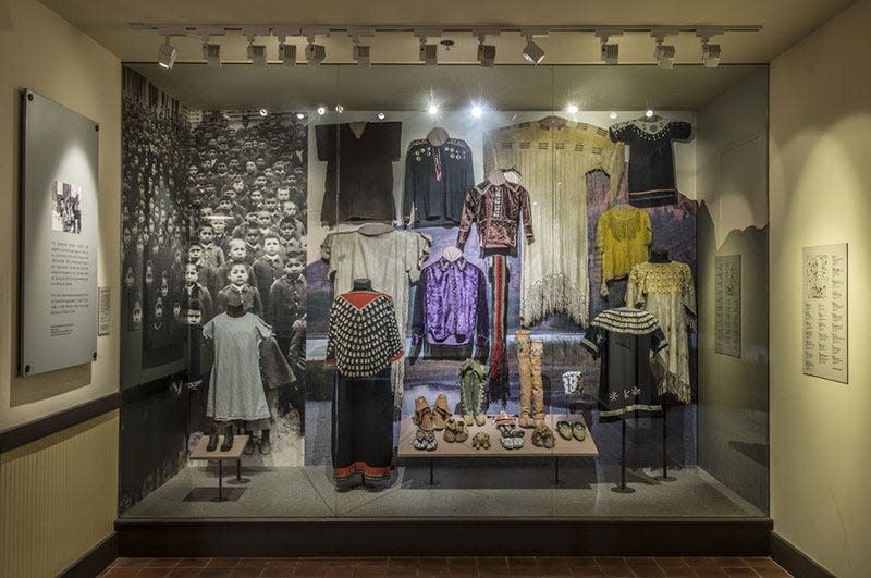 'Arrival' section with a case housing traditional clothing that would have been replaced by uniforms in the original 'Away from Home: American Indian Boarding School Stories' exhibition at the Heard Museum.