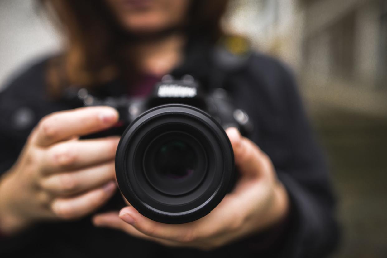 dslr camera in woman's hands