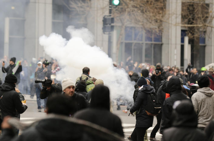 <p>Police deploy smoke and pepper grenades during clashes with protesters in northwest Washington, Friday, Jan. 20, 2017. (AP Photo/Mark Tenally) </p>