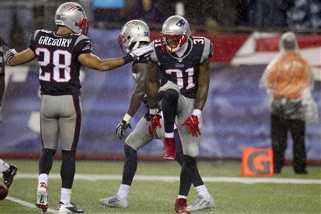 New England Patriots Aqib Talib (31) celebrates with Steve Gregory his first interception against the New York Jets during their NFL AFC East football game in Foxborough, Massachusetts, September 12, 2013. REUTERS/Dominick Reuter