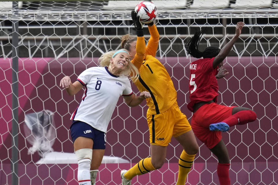 United States' goalkeeper Alyssa Naeher, center, catches a ball during a women's semifinal soccer match against Canada at the 2020 Summer Olympics, Monday, Aug. 2, 2021, in Kashima, Japan. (AP Photo/Andre Penner)