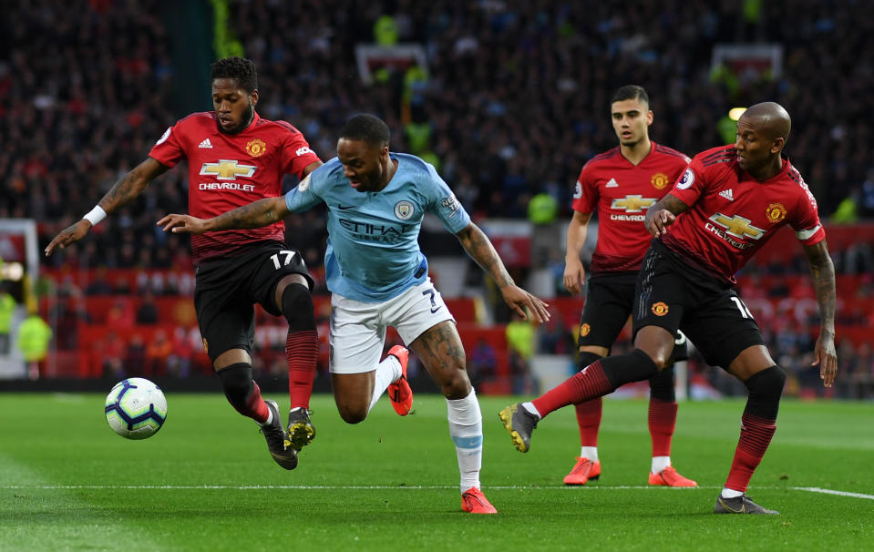 Fred and Ashley Young of Manchester United battle for possession with Raheem Sterling of Manchester City during the Premier League match between Manchester United and Manchester City