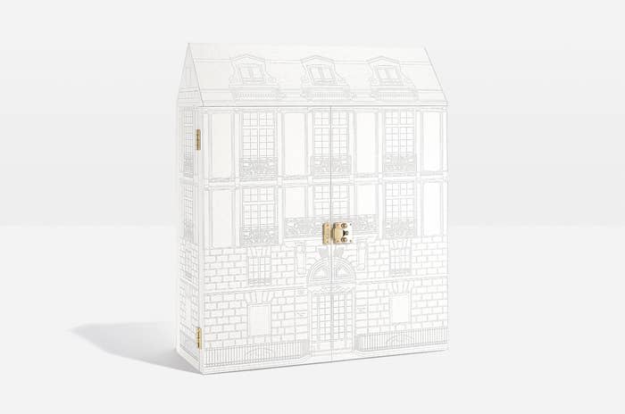 A large box designed to look like a building while it's closed, with a latch on the front to open it and reveal the advent calendar inside