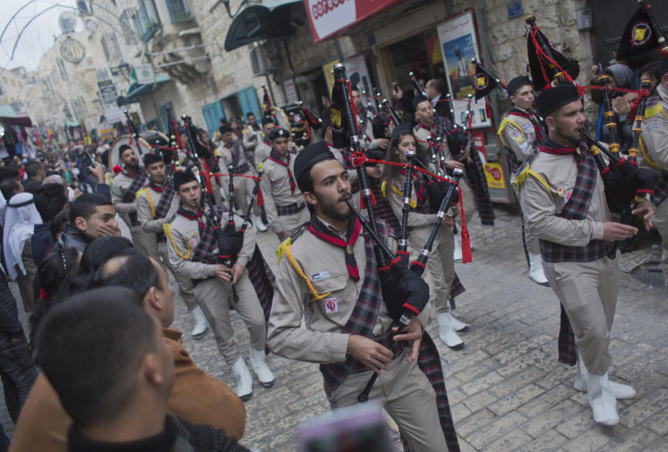 Palestinian scouts march through town ahead of midnight Mass at the Church of the Nativity, traditionally recognized by Christians to be the birthplace of Jesus Christ, in the West Bank city of Bethlehem, Monday, Dec. 24, 2018. Palestinians are preparing to host pilgrims from around the world in celebrating Christmas in the West Bank city of Bethlehem. (AP Photo/Nasser Nasser)