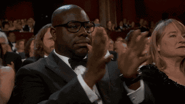 Steve, in bow tie and glasses, applauding by pounding his hands with spread fingers together