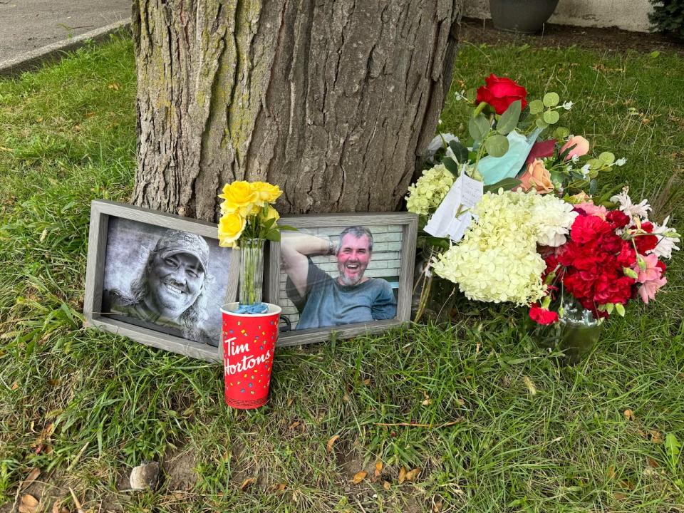 A memorial for 67-year-old Walter Lasher of Greater Napanee, Ont., lies on the front lawn of where he lived after he died in a suspicious fire on Aug. 3, 2024.