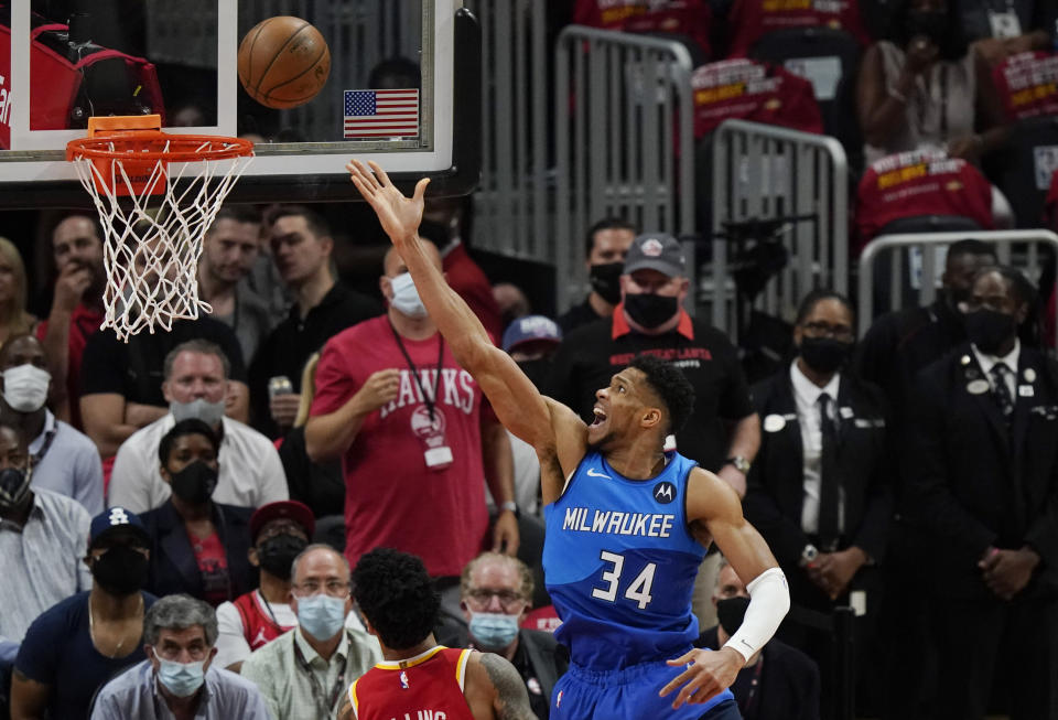 Milwaukee Bucks' Giannis Antetokounmpo (34) scores against the Atlanta Hawks during the first half of Game 3 of the NBA Eastern Conference basketball finals Sunday, June 27, 2021, in Atlanta. (AP Photo/Brynn Anderson)