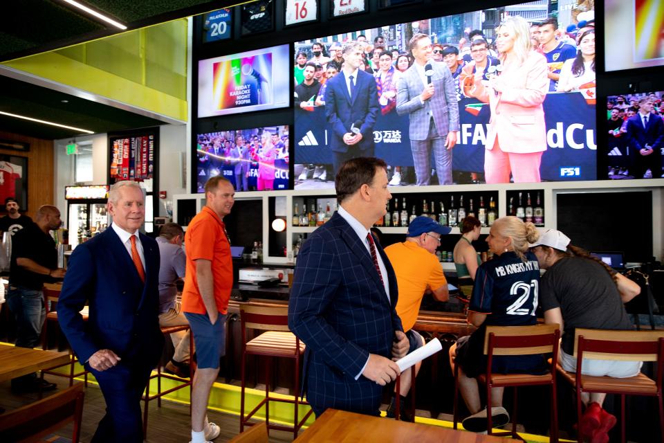 Jeff Berding and Carl Lindner III, 2026 Cincy Local Organizing Executive Committee members, greet fans after the watch party for the U.S. Host Cities for the FIFA World Cup 2026 at The Pitch in Over-The-Rhine on Thursday, June 16, 2022. Cincinnati was not selected. 