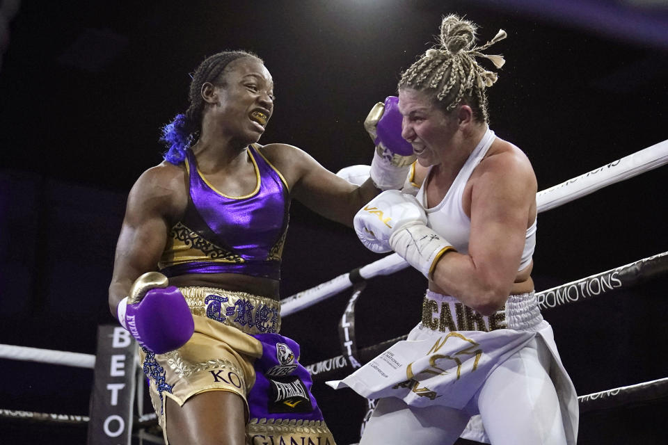 FILE - In this March 5, 2021, file photo, Claressa Shields, left, hits Marie-Eve Dicaire with a left during the fifth round of a boxing bout for the women's super welterweight title in Flint, Mich. Shields did it all in boxing. Two-time Olympic gold medalist. Professional titles in three weight classes. Now she'll try to conquer MMA, starting with her pro debut for Professional Fighters League on Thursday night, June 10, 2021, in Atlantic City, N.J. (AP Photo/Carlos Osorio, File)