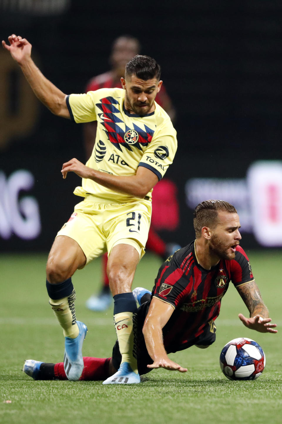 Club America forward Henry Martin (21) takes the ball away from Atlanta United defender Leandro Gonzalez (5) during the first half of a Campeones Cup soccer match Wednesday, Aug. 14, 2019, in Atlanta. (AP Photo/John Bazemore)