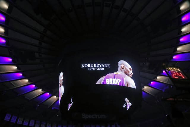 The ceiling of Madison Square Garden is lit in the colours of the Los Angeles Lakers as Kobe Bryant’s picture is displayed on a video screen