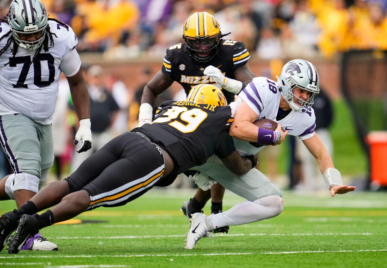 Sep 16, 2023; Columbia, Missouri, USA; Kansas State Wildcats quarterback Will Howard (18) is tackled by Missouri Tigers defensive lineman Realus George Jr. (99) and defensive lineman Johnny Walker Jr. (15) during the first half at Faurot Field at Memorial Stadium. Mandatory Credit: Jay Biggerstaff-USA TODAY Sports