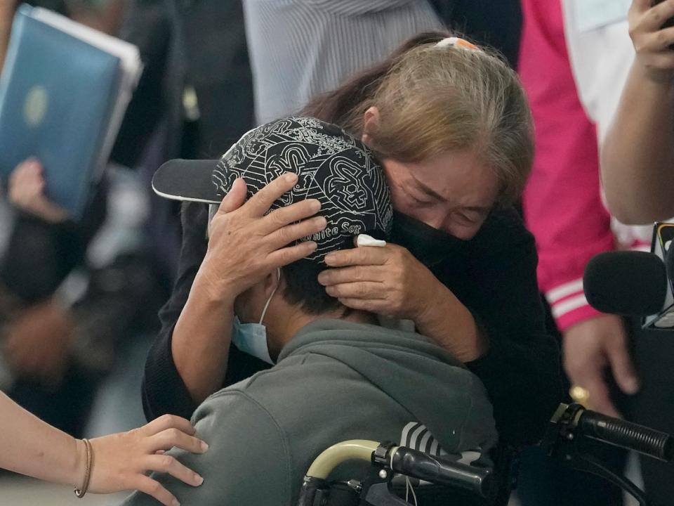 A relative hugs a Thai overseas worker who was evacuated from Israel, on his arrival at Suvarnabhumi International Airport in Samut Prakarn Province, Thailand, Thursday, Oct. 12, 2023.