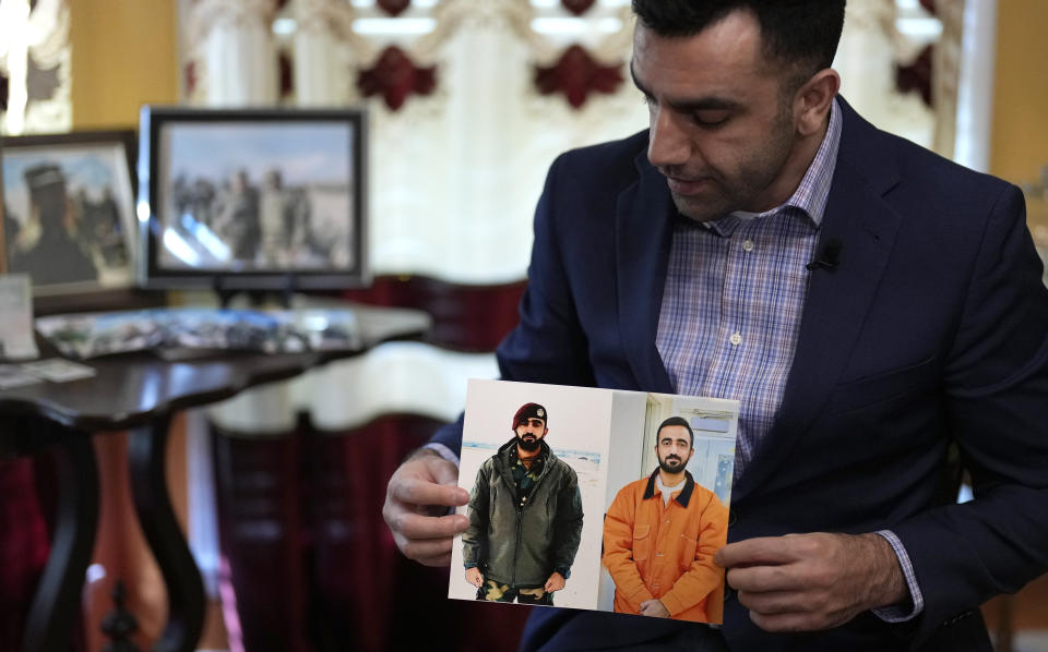 Sami-ullah Safi holds photographs of his brother, Abdul Wasi Safi, as he talks about his brother's journey to the U.S. during an interview Wednesday, Jan. 18, 2023, in Houston. Safi's brother, who's called Wasi by his family, was an intelligence officer with the Afghan National Security Forces, providing U.S. armed forces with information for operations against terrorists, said Sami-ullah Safi. Wasi was arrested after crossing the U.S.-Mexico border near Eagle Pass, Texas in September 2022, and charged with a federal misdemeanor related to wrongly entering the country and placed in a detention center in Central Texas. (AP Photo/David J. Phillip)