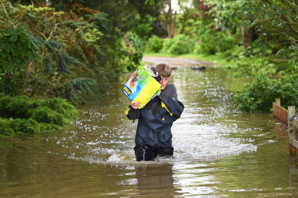 A man wades through floodwater in Wainfleet All Saints, in Lincolnshire (Joe Giddens/PA Wire)