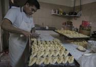 An employee prepares food at a bakery in Buenos Aires on June 23, 2018