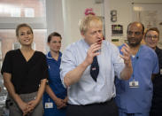 Britain's Prime Minister Boris Johnson speaks during a visit to North Manchester General Hospital before the Conservative Conference, in Manchester, England, Sunday, Sept. 29, 2019. British Prime Minister Boris Johnson has urged calm as tempers flare in the debate over Britain's departure from the European Union, even though tempers are flaring over what he said. A defiant Johnson told the BBC on Sunday that the "best thing for the country and for people's overall psychological health would be to get Brexit done." (Andy Stenning/Pool Photo via AP)