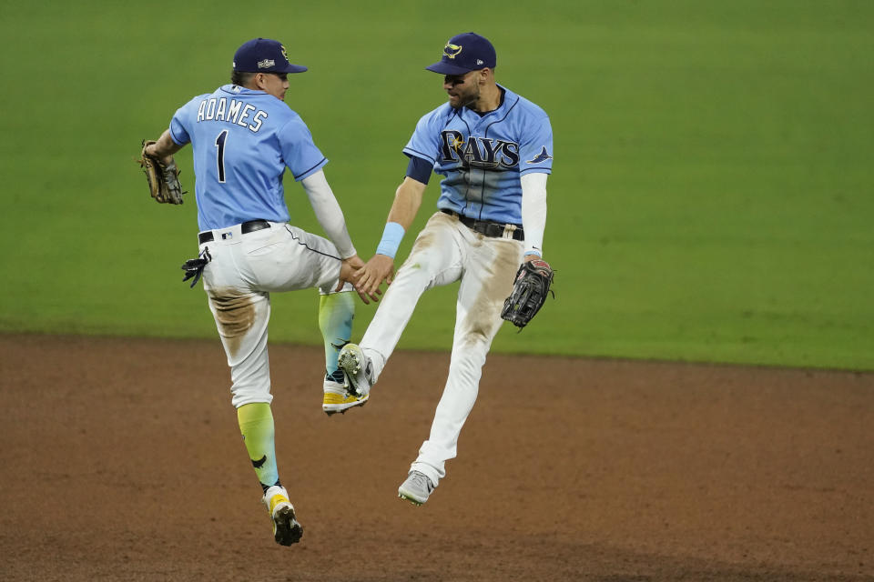 Tampa Bay Rays second baseman Brandon Lowe and Willy Adames (1) celebrate their victory against Houston Astros in Game 1 of a baseball American League Championship Series, Sunday, Oct. 11, 2020, in San Diego. The Rays defeated the Astros 2-1 to lead the series 1-0 games. (AP Photo/Ashley Landis)