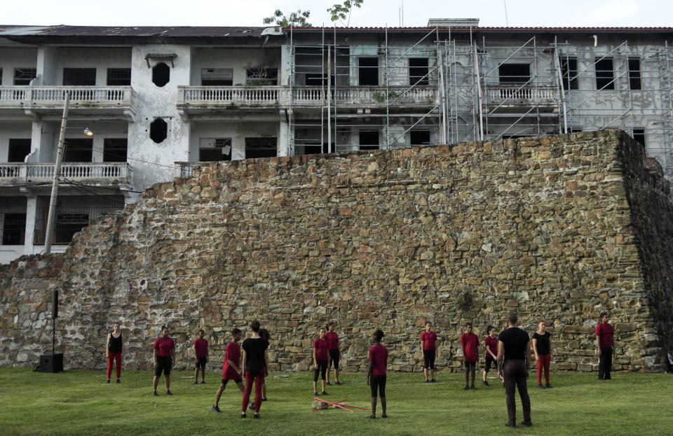 In July 28, 2019 photo, actors perform in front of the old wall that protected the Casco Viejo of Panama City, ahead of the 500 anniversary of the founding of the City. This second city was built on a peninsula completely isolated by the sea and a defensive system of walls. On the eve of the 500 anniversary of the founding of Panama City, this place preserves the first institutions and buildings of the modern city of Panama. (AP Photo/Arnulfo Franco)