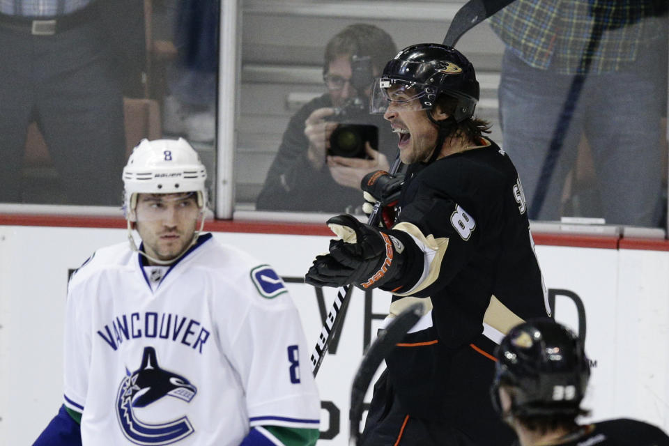 Anaheim Ducks' Teemu Selanne, right, of Finland, celebrates his goal as Vancouver Canucks' Chris Tanev looks on during the first period of an NHL hockey game on Wednesday, Jan. 15, 2014, in Anaheim, Calif. (AP Photo/Jae C. Hong)