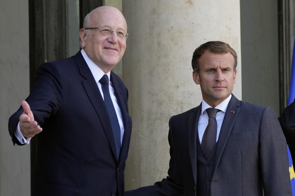 French President Emmanuel Macron, right, welcomes Lebanese Prime Minister Najib Mikati prior to their meeting at the Elysee Palace, in Paris, Friday, Sept. 24, 2021. (AP Photo/Francois Mori)