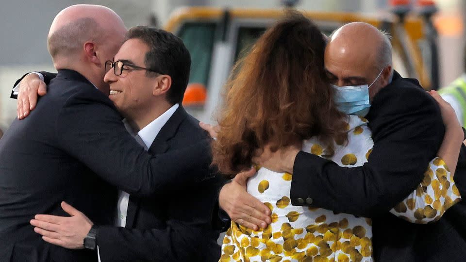 US citizens Siamak Namazi (2nd-L) and Morad Tahbaz (R) are welcomed by people upon disembarking from a Qatari jet upon their arrival at the Doha International Airport in Doha on September 18, 2023.(Photo by AFP) (Photo by -/AFP via Getty Images) - AFP/Getty Images