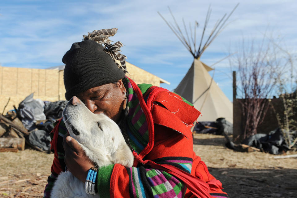 <p>Dan Nanamkin from the Nez Perce tribe hugs his dog during a protest against the Dakota Access pipeline near the Standing Rock Indian Reservation near Cannon Ball, North Dakota, U.S. November 13, 2016. (Photo: Stephanie Keith/Reuters) </p>