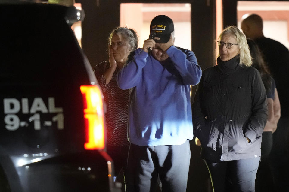 People depart a reunification center early Thursday, Oct. 26, 2023, at Auburn Middle School, in Auburn, Maine, after several fatal shootings in Lewiston. (AP Photo/Steven Senne)