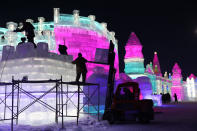 <p>Workers carve ice sculptures one day ahead of the opening of the 34th Harbin International Ice and Snow Festival in China’s Heilongjiang province on Jan. 4. (Photo: Wu Hong/EPA-EFE/REX/Shutterstock) </p>