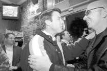 Democratic presidential hopeful Sen. John Edwards, D-N.C., center, chats with Art Alexakis, lead singer of the band Everclear, right, at a bar in Charleston, S.C., in 2004. AP Photo