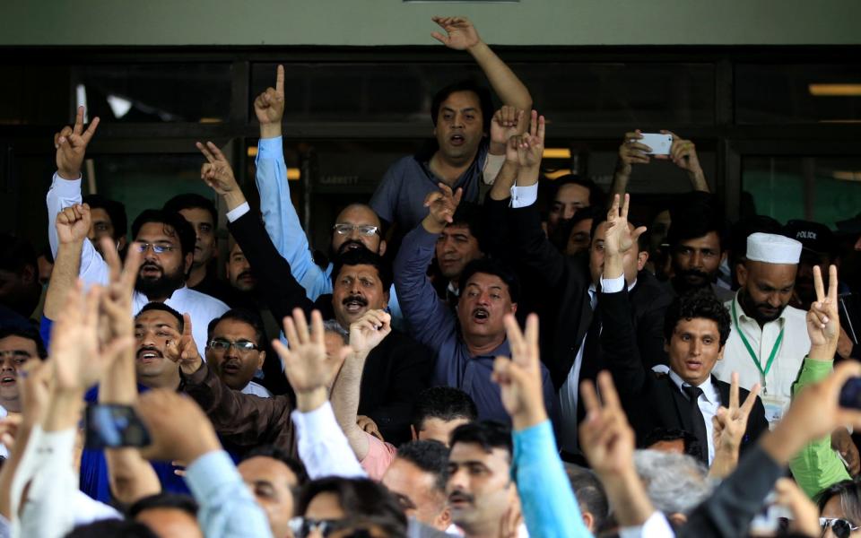 Opponents of Prime Minister Nawaz Sharif shout slogans as they exit the Supreme Court in Islamabad, Pakistan July 28 - Credit: REUTERS