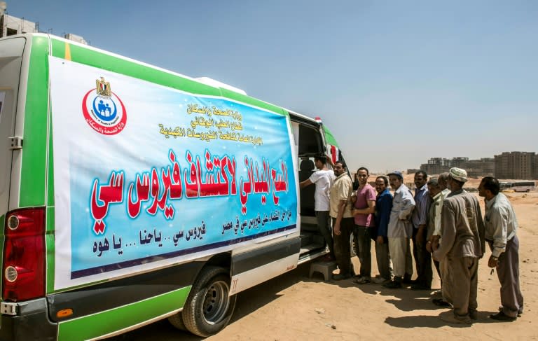 Egyptian workers line up for a Hepatitis C test at a construction site near Cairo on August 3, 2017