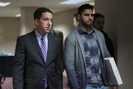 Glenn Greenwald (L) arrives for a news conference next to his partner David Miranda after receiving the George Polk Awards in New York, April 11, 2014. REUTERS/Eduardo Munoz