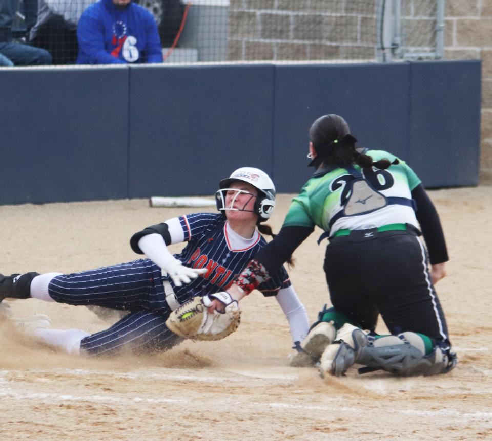 Pontiac's Maddie Gourley gets tagged out at the plate by Dwight catcher Avery Scheuer during Monday's softball game at The Diamond at Williamson Field. PTHS won the game 11-0.