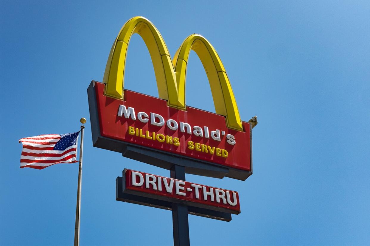 The sign for McDonald's drive in take-away restaurant and an American flag in the Silver Lake area of Los Angeles. (Photo by Epics/Getty Images)