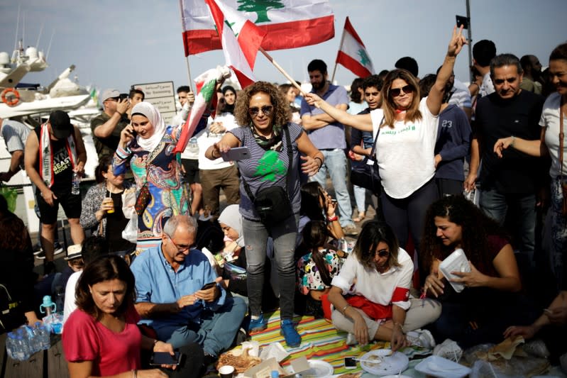 Protesters take part in the ongoing anti-government protests in Beirut