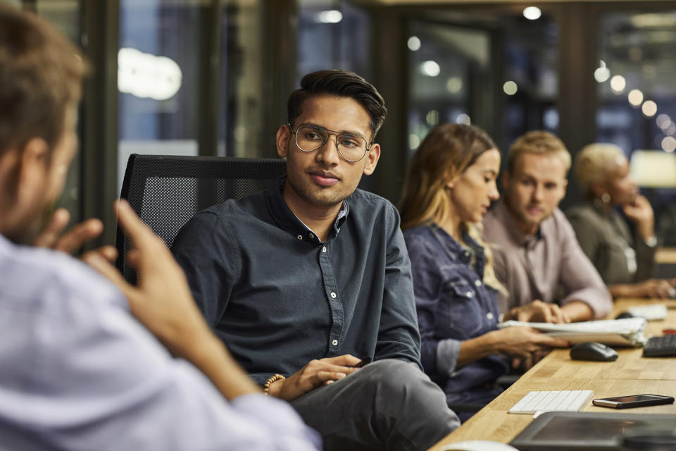 Colleagues chatting in an office conference room