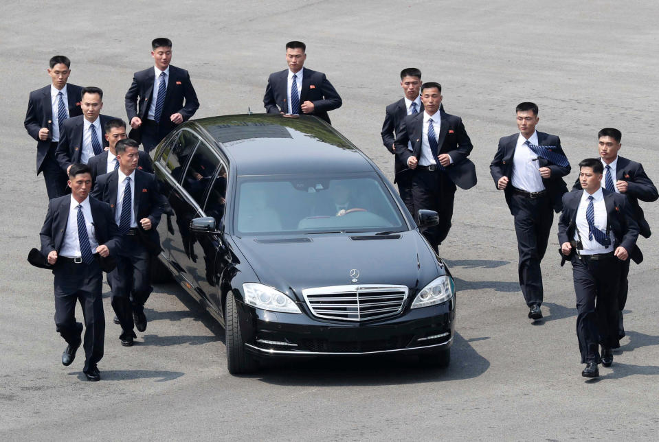 FILE - In this April 27, 2018, file photo, North Korean security persons run by a car carrying North Korean leader Kim Jong Un return to the North side for a lunch break after a morning meeting with South Korean President Moon Jae-in at the border village of Panmunjom in Demilitarized Zone. Kim and South Korean President Moon Jae-in announced in the North Korean capital of Pyongyang this week that Kim has accepted Moon’s request to visit Seoul soon, maybe within the year.(Korea Summit Press Pool via AP, File)