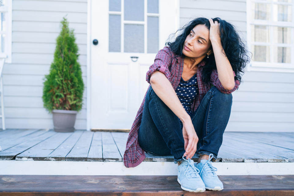 A woman sitting on her front porch