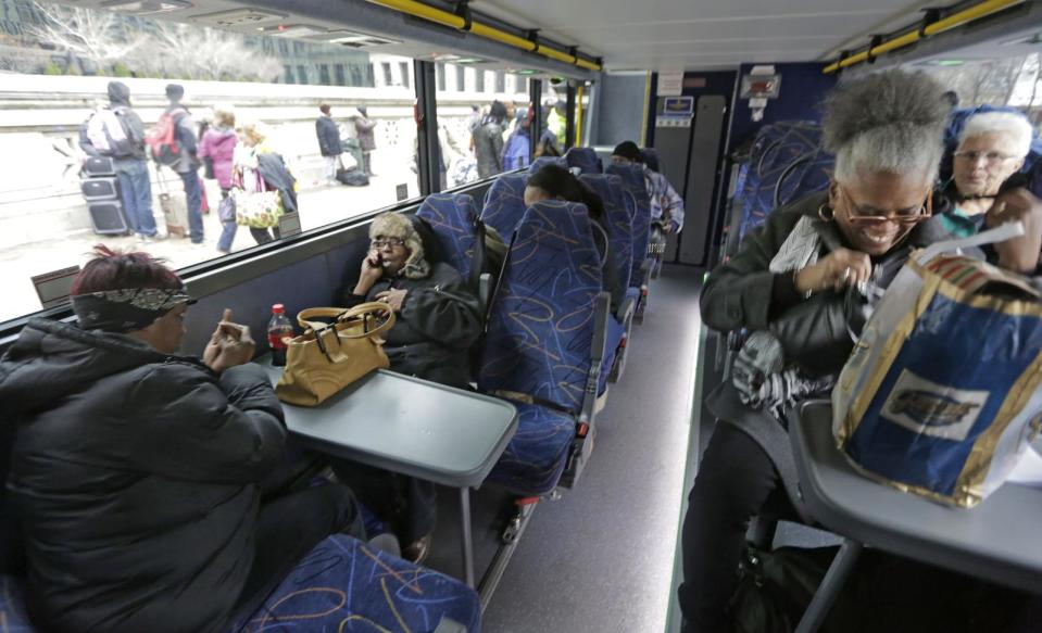 Passengers settle in on a Megabus headed to St. Louis, and Memphis, Tuesday, Nov. 26, 2013, in Chicago. Millions of Americans are hurtling along the nation's jumble of transportation arteries for Thanksgiving, and more of them are discovering that a bus, of all things, is the cheapest, comfiest and coolest way to stay Zen during the nation's largest annual human migration. (AP Photo/M. Spencer Green)